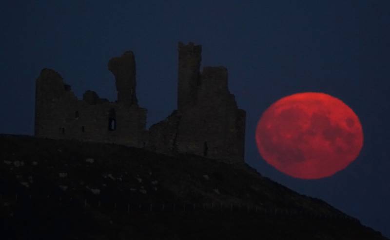 The Sturgeon supermoon, the final supermoon of the year rises over Dunstanburgh Castle in Northumberland. Picture date: Thursday August 11, 2022. (Photo by Owen Humphreys/PA Images via Getty Images)