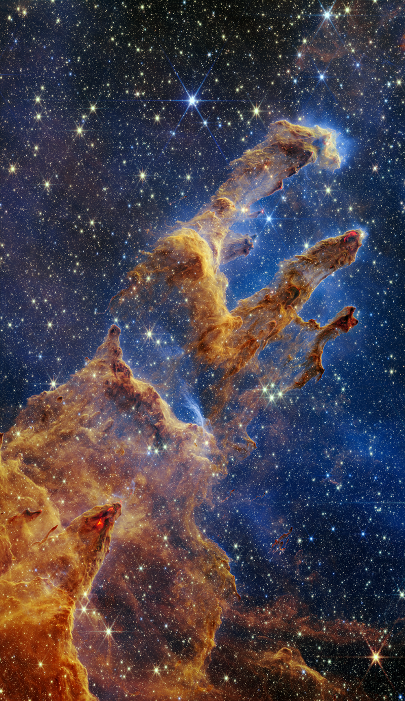 The Pillars of Creation as captured by NASA's James Webb Space Telescope look like arches and spires and are filled with semi-transparent gas and dust. This is a region where young stars are forming.