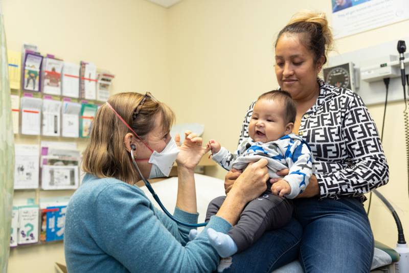 Pascale Fisher, a family nurse practitioner, checks a baby’s heartbeat at La Clínica's San Antonio Neighborhood Health Center in Oakland.