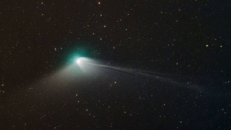 A bright green comet with a long white tail.