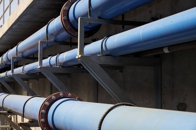 An image of three levels of big blue pipes.