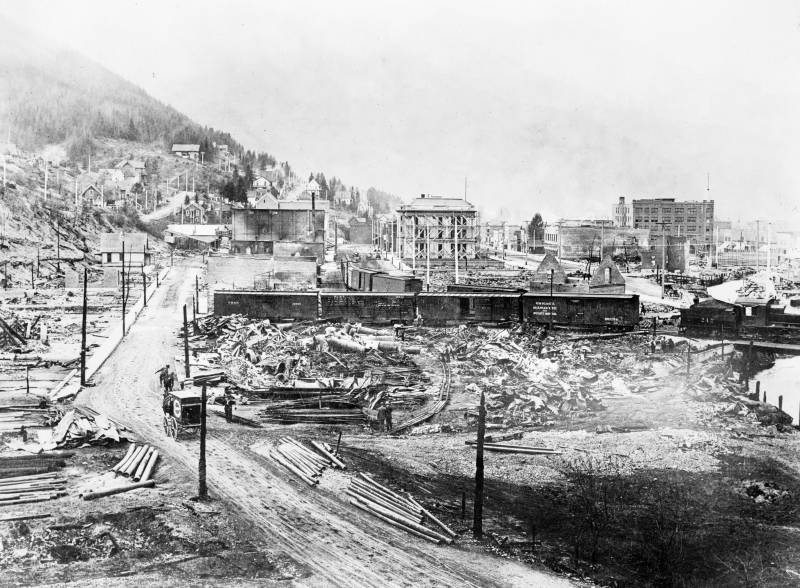 A black and white photograph of a town destroyed by fires. 