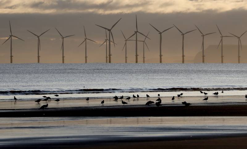 An offshore wind farm is visible from the beach in Hartlepool, England