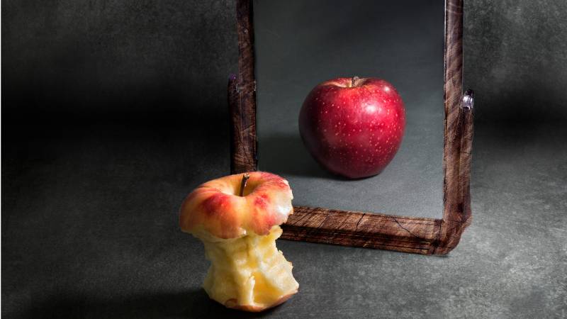 chewed apple sees self as full in mirror
