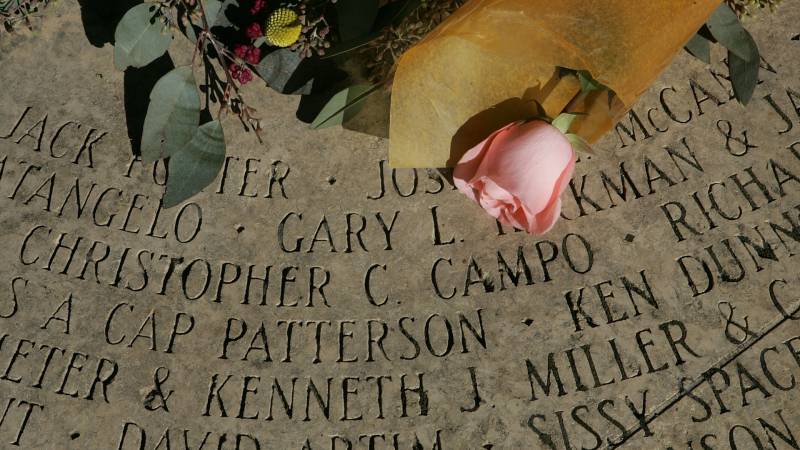 A rose is seen placed on the "Circle of Friends," a ring of names engraved in stone to honor those who have been affected by AIDS at the AIDS Memorial Grove