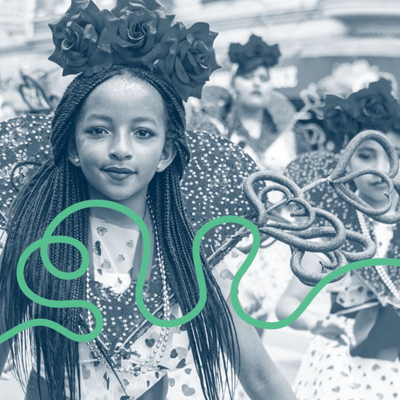 Young girl with black braids and a rose crown among Carnaval paraders.