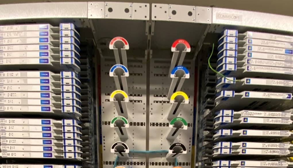 Several color-coded rods are surrounded by wires and other technical equipment; close up image.