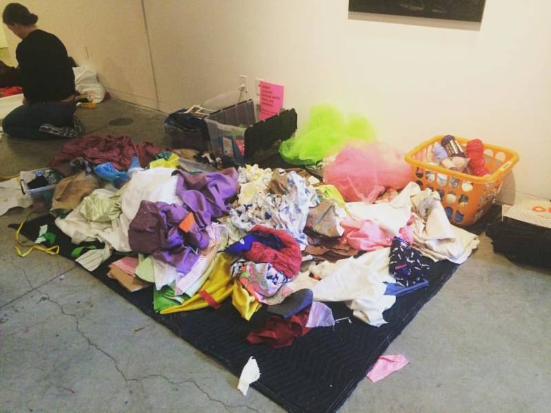 A giant scrap fabric pile, collectively donated by visitors and participants to the Reap What You Sew protest signage workshop at Southern Exposure.