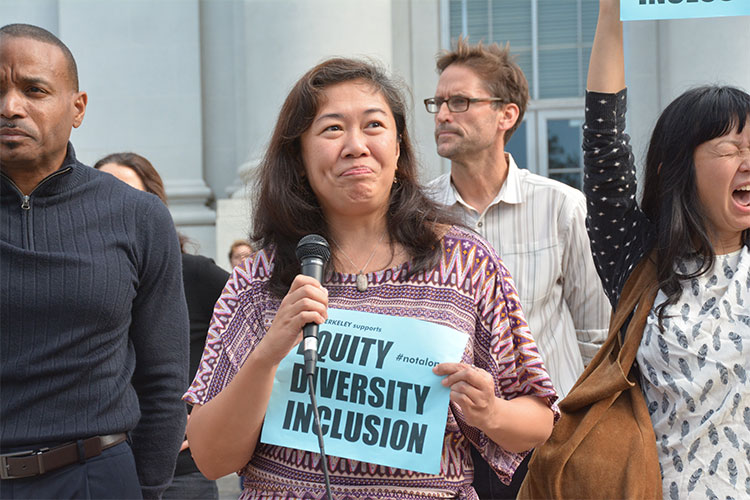 Catherine Ceniza Choy, professor in the Department of Ethnic Studies holds the microphone, professor Stephanie Syjuco on the right.