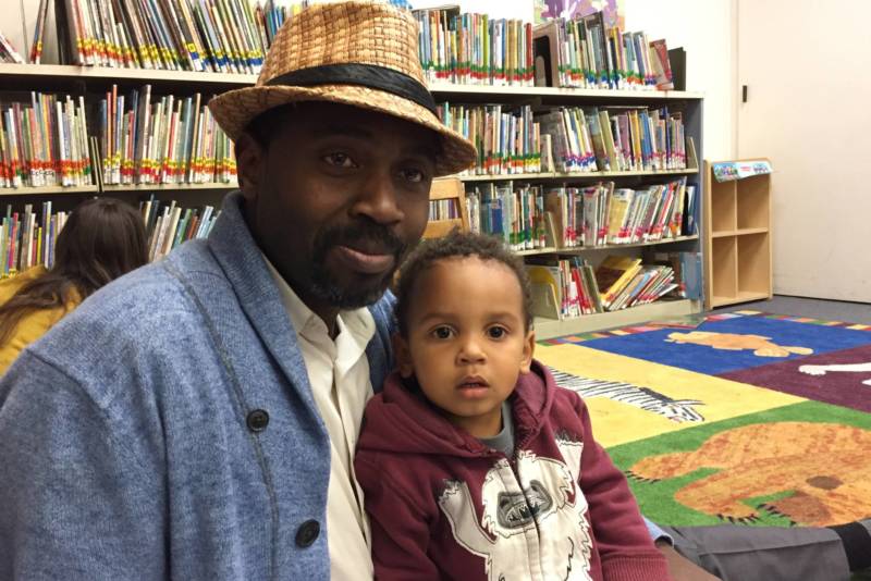 Solomon Makoni and his son Tadashe at story time at the Dimond Branch of the Oakland Public Library