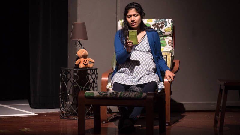 Priya Kumar, played by Devika Ashok, waits impatiently by the phone as her husband struggles to get back home in Airport Insecurity, produced by the Santa Clara-based theater company Naatak.
