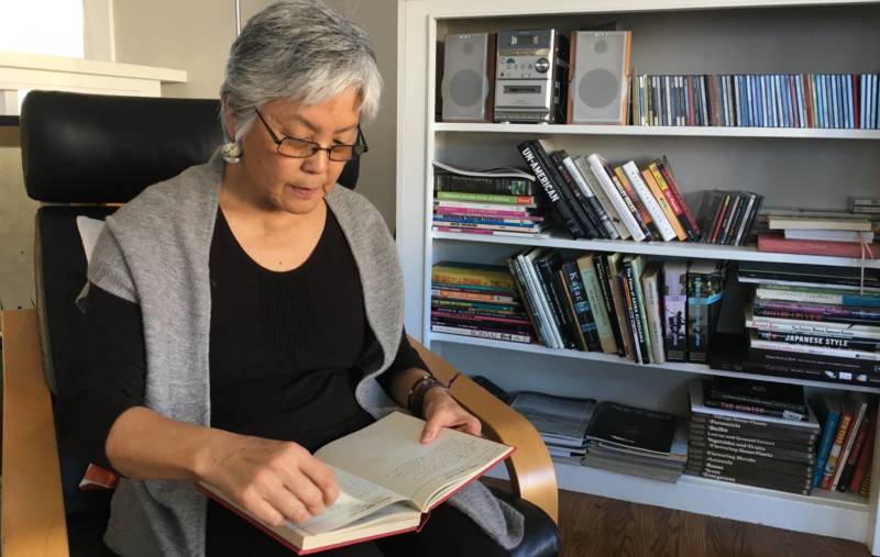 Satsuki Ina reads her mothers journal at home in Berkeley.
