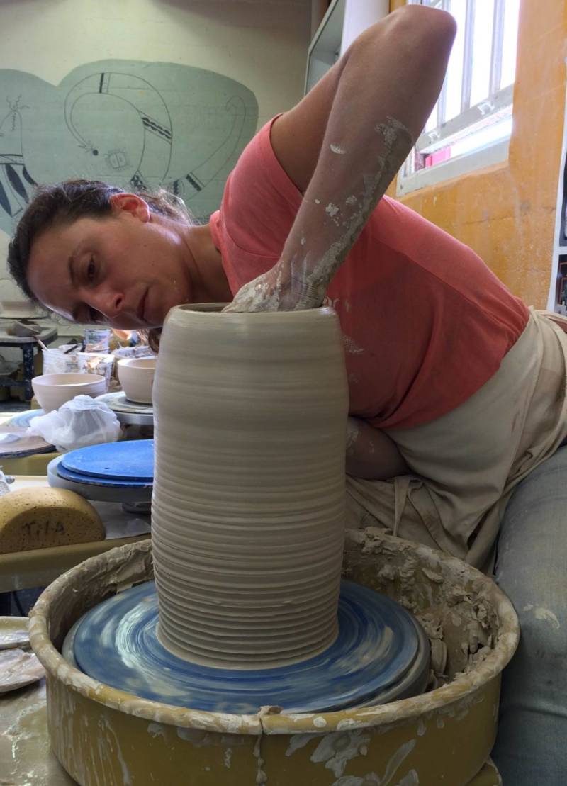 A City College of San Francisco student make a pot in ceramics class at the college's Fort Mason campus