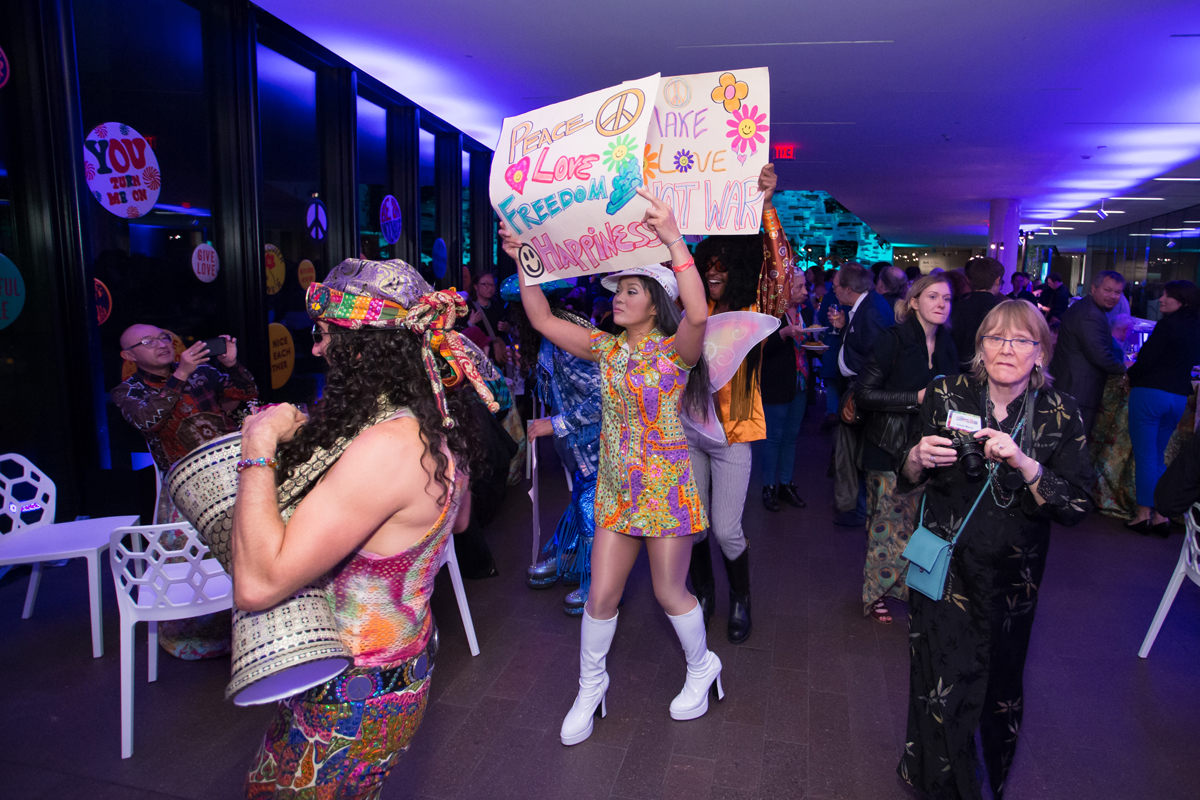 Performers "protesting" at 'The Summer of Love Experience' donor reception at de Young Museum.