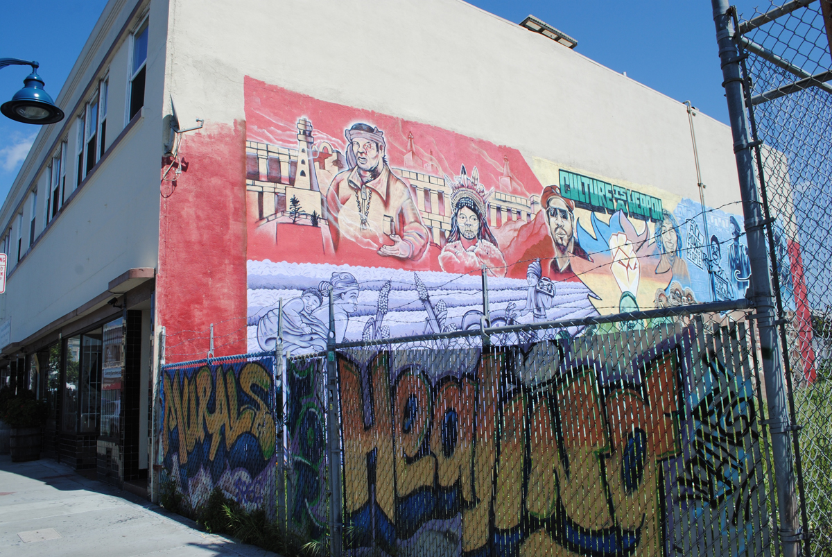 A mural on the building's exterior, at the corner of 23rd Avenue and International in Oakland.