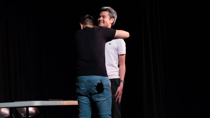 In "Awkward Hug," a son, played by Stanford student Jason Li, has to beg for a physical expression of affection from his father, played by Dr. Steven Sust. 