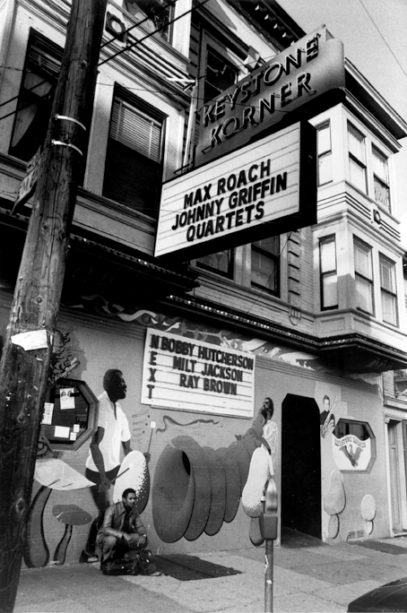 Exterior view circa 1982 of the Keystone Korner in North Beach. Saxophonist Odean Pope of the Max Roach Quartet poses in front.  