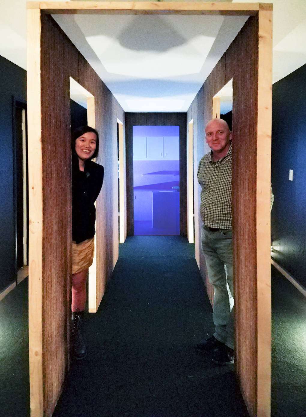 Amy M. Ho with collaborator Dennis Crookes standing inside installation for 'Spaces From Yesterday: The Hallway' at Oakland's Royal NoneSuch Gallery.