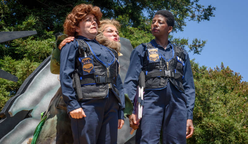 ICE Agent Cliodhna Abhabullogue (Lizzie Calogero), Leprechaun (Marilet Martinez) and L. Mary Jones (Velina Brown) discuss the meaning of immigration in 'Walls' by the San Francisco Mime Troupe.