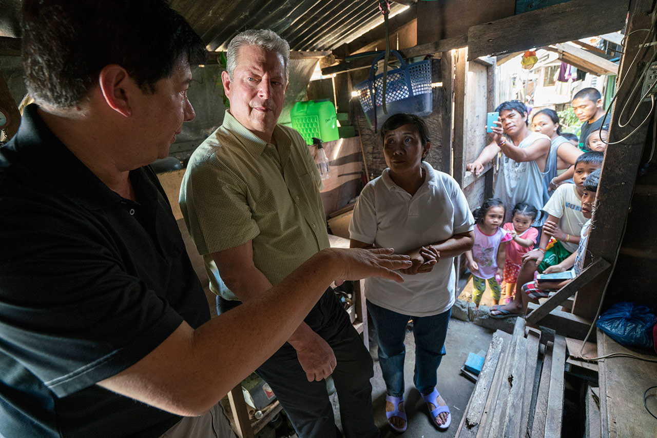 Al Gore with former Mayor of Tacloban City Alfred Romualdez and Typhoon Haiyan survivor Demi Raya, in the Raya family home; Tacloban City, Philippines, March 12, 2016.