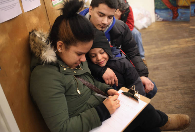 A family fills out an application for Deferred Action for Childhood Arrivals (DACA), at a workshop on February 18, 2015 in New York City. 