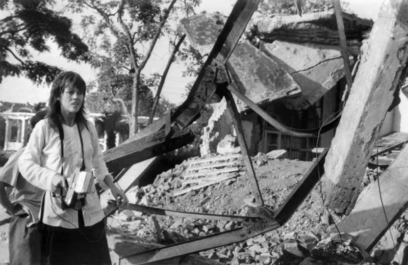 Jane Fonda, holding a camera, visits 25 July 1972 a Hanoi site bombed by US airplanes. Fonda's trip to North Vietnam was part of her protest campaign against the US involvement in the Vietnam war. US bombers, including B-52 strato-fortresses, started to bomb the North Vietnamese capital and its port Haiphong in April 1972.  