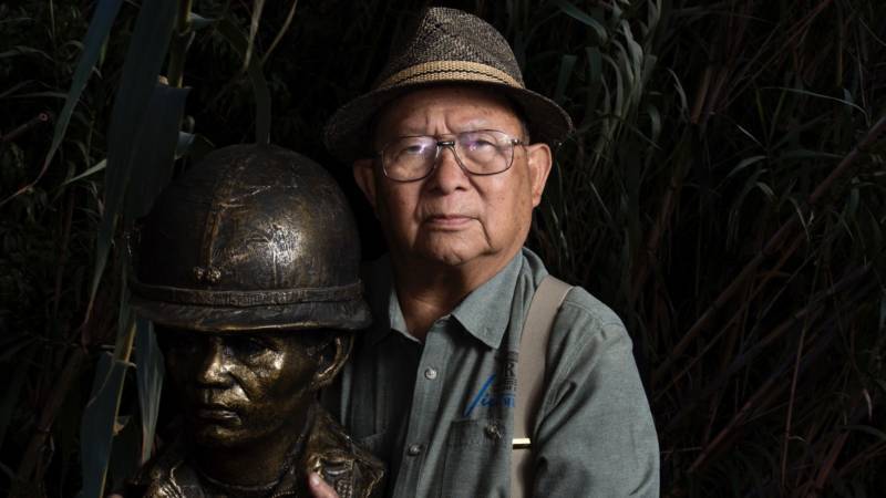 Loc Vu, an 85-year-old retired colonel who served in the Army of the Republic of Vietnam, holds a bust of a South Vietnamese soldier at the Viet Museum in San Jose. "This is a beautiful work from the museum," he says. "It reminds me of the unknown soldier."