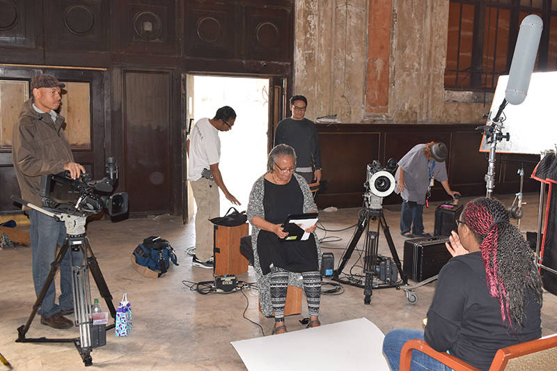 Filmmaker Cheryl Fabio (center) on set at 16th Street Station. 
