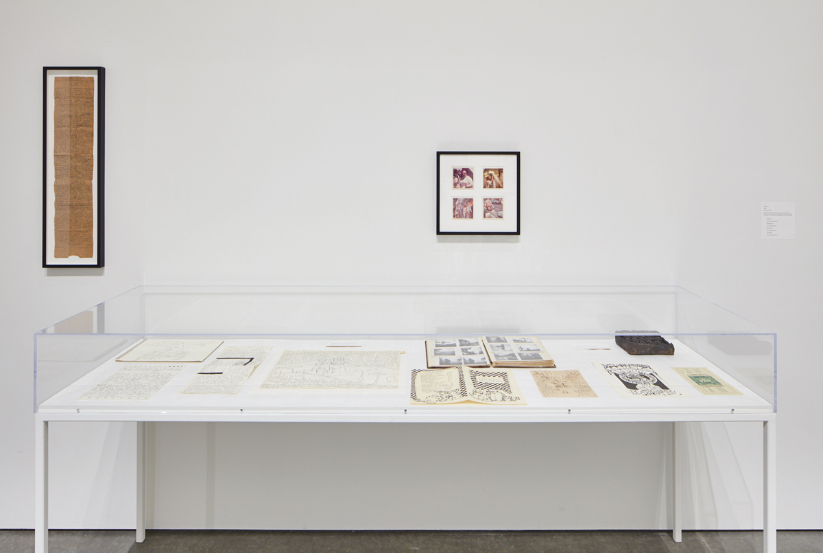 Installation view with vitrine containing 'First letter home.'