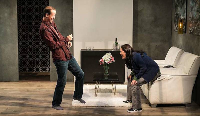 (L to R) Ian (Robert Parsons), the bouquet of flowers, and Cate (Adrienne Walters) negotiate a deadly dance in 'Blasted' by Sarah Kane.