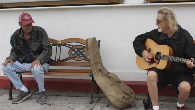 Musician Buzzy Martin entertains a passerby at a Santa Rosa shelter.