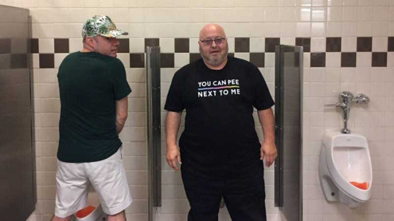 Transgender member of the San Francisco Gay Men's Chorus Tom Kennard poses in the men's bathroom at a rest stop en route from Birmingham, AL to Knoxville, TN. Kennard was one of a group of 250 singers traveling through the south on the choir's 'Lavender Pen Tour'.