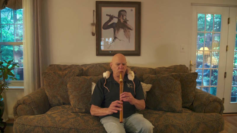 Louis Eagle Warrior, celebrated musician and member of the Lenape Indian Nation, plays the flute in his living room.