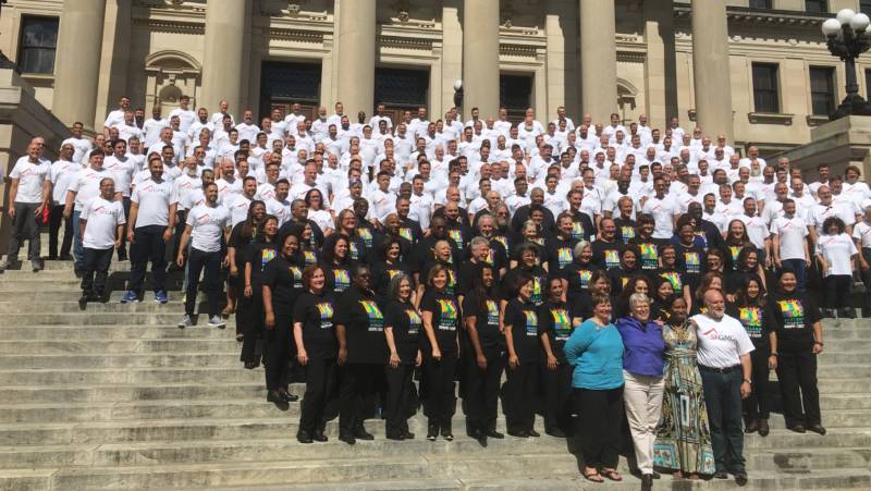 Members of The San Francisco Gay Mens Chorus and the Oakland Interfaith Gospel Choir gather on the steps of the Mississippi State Capitol to sing.