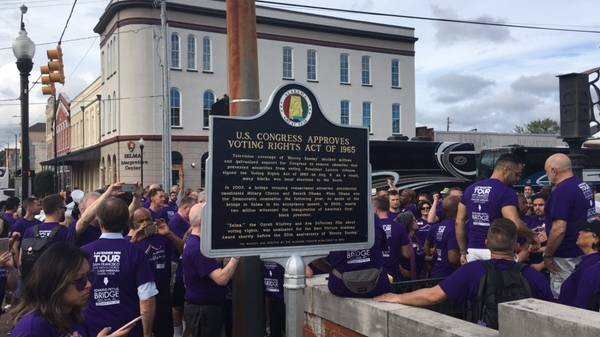 Singers from the San Francisco Gay men's Chorus and Oakland Interfaith Gospel Choir pour onto Edmund Pettus Bridge in Selma, Alabama, on the second day of their tour around five southern states.
