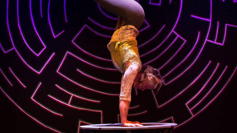 Eka.Boo.Button performs a very long handstand in 'Circus Veritas' by Kinetic Arts production.