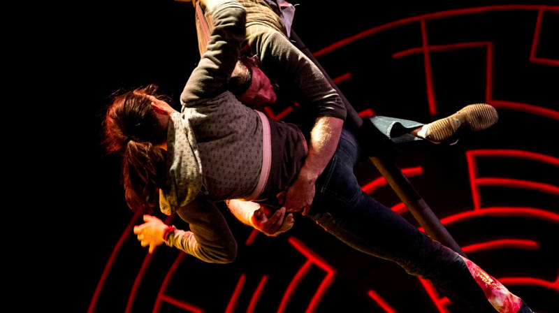 Jane Doe (Emily Rose Phillips) hangs onto Frank Conner Ponzi III (Ross Tavis) rather high up in the air in 'Circus Veritas' produced by Kinetic Arts.
