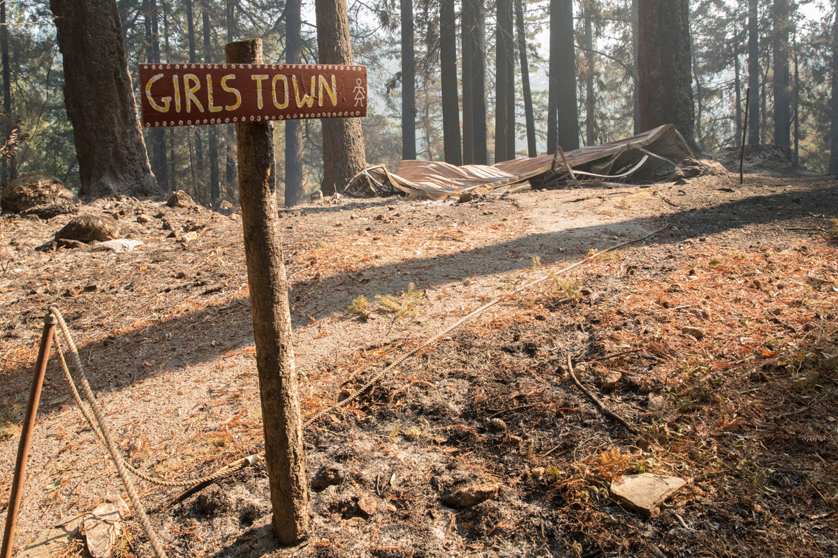 The ‘Girls Town’ sign stands in front of the leveled girl’s cabins.