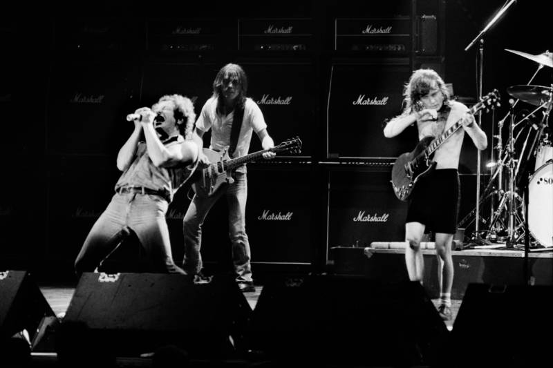 (LtoR) Singer Brian Johnson performs next to guitarists Malcolm Young and Angus Young of Australian legendary hard rock band AC/DC at the Palais Omnisport of Paris Bercy, on September 15, 1984 in Paris.     