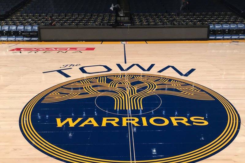 The Warriors' 'Town' logo at center court.
