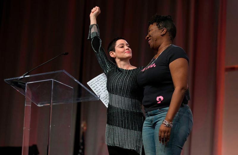 US actress Rose McGowan and Founder of #MeToo Campaign Tarana Burke, embrace on stage at the Women's March / Women's Convention in Detroit, Michigan, on October 27, 2017. 