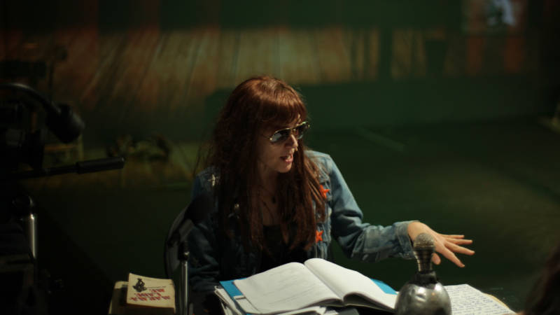 Jill Johnston (Kate Valk) surveys her desk for clues to a wild evening in 'Town Hall Affair' by the Wooster Group.