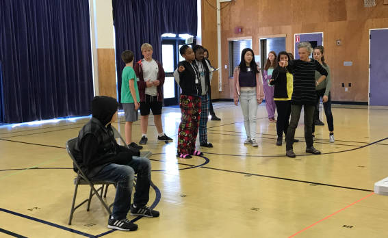 Director Erin Neff works with 8th graders from Rooftop Alternative School on a scene from the new opera 'Harriet's Spirit'