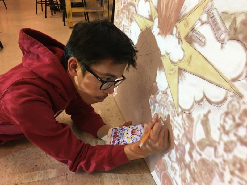 Student Jason Capuyan works on his mural -- the cover art for Green Days 1994 album ‘Dookie’.