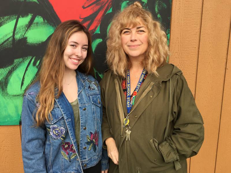 Art teacher Jan Barzottini right) poses with recent grad Shaye Maxey. Maxey won a full ride scholarship to the Academy of Art University, partly for her work on the mural project.