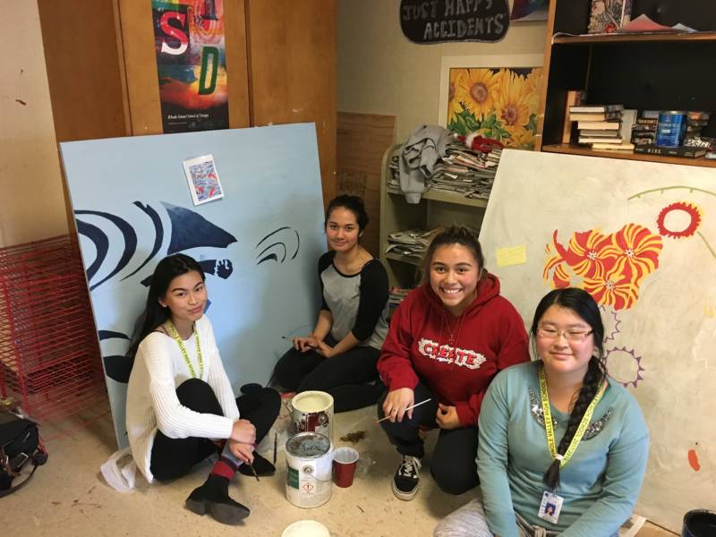 Pinole Valley High students pose in front of their work.
