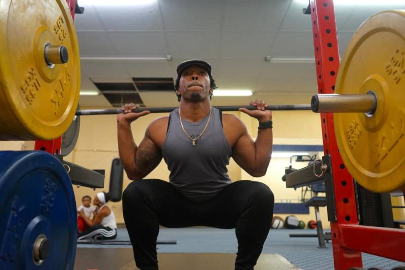 Ant Petty getting active on the weights as his family watches in the background.