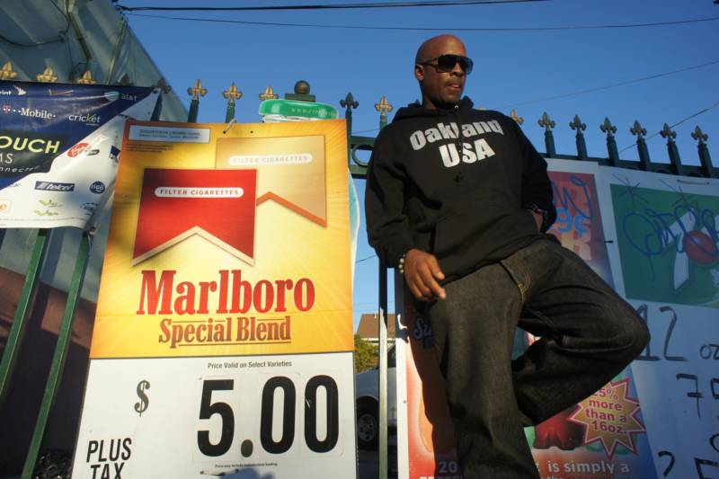 East Oakland native, rapper Richie Rich, poses for a photo outside of a store in North Oakland.