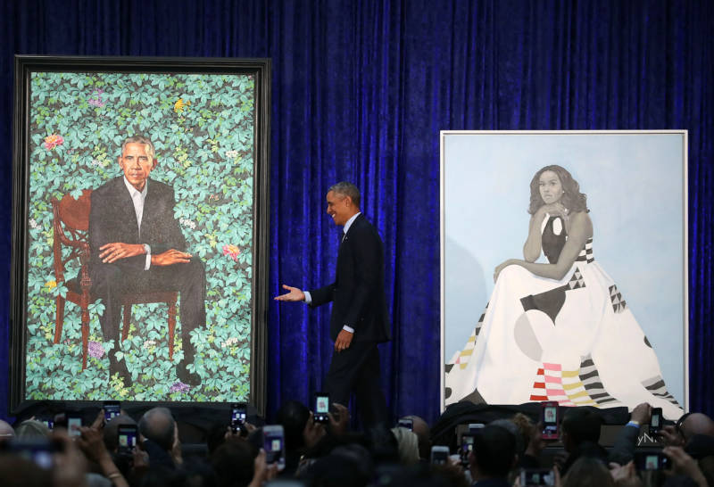 Former President Barack Obama stands with his and former first lady Michelle Obama's newly unveiled portraits during a ceremony at the Smithsonian's National Portrait Gallery in Washington, D.C.