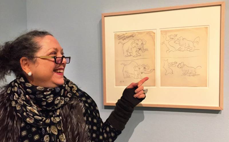 Rube Goldberg's granddaughter Jennifer George points to a cartoon that she and her grandfather worked on together when she was a child